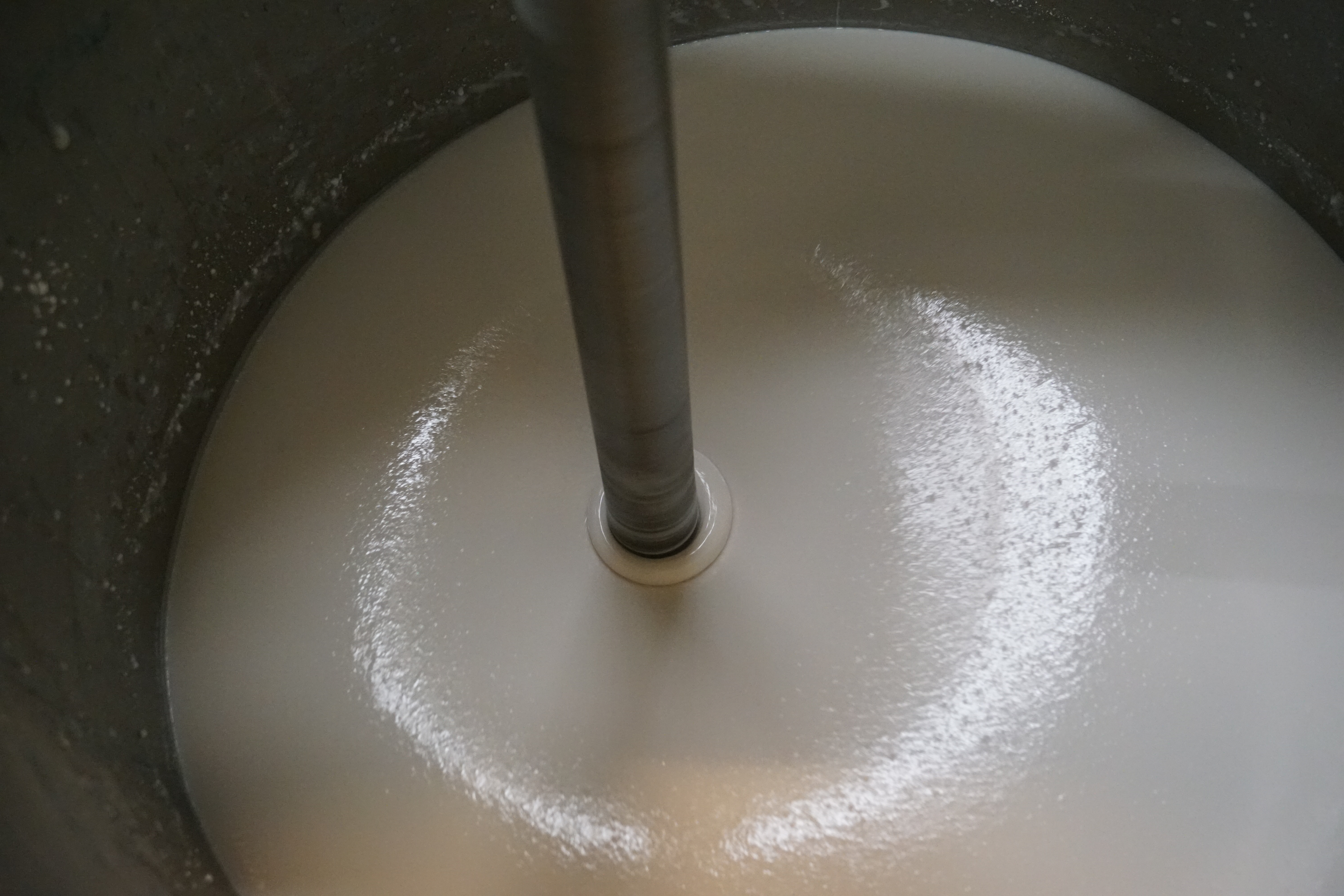 Maskine rører i hvid maling