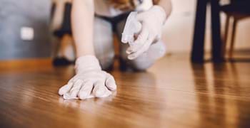Female cleaning the floor with Faxe stain remover