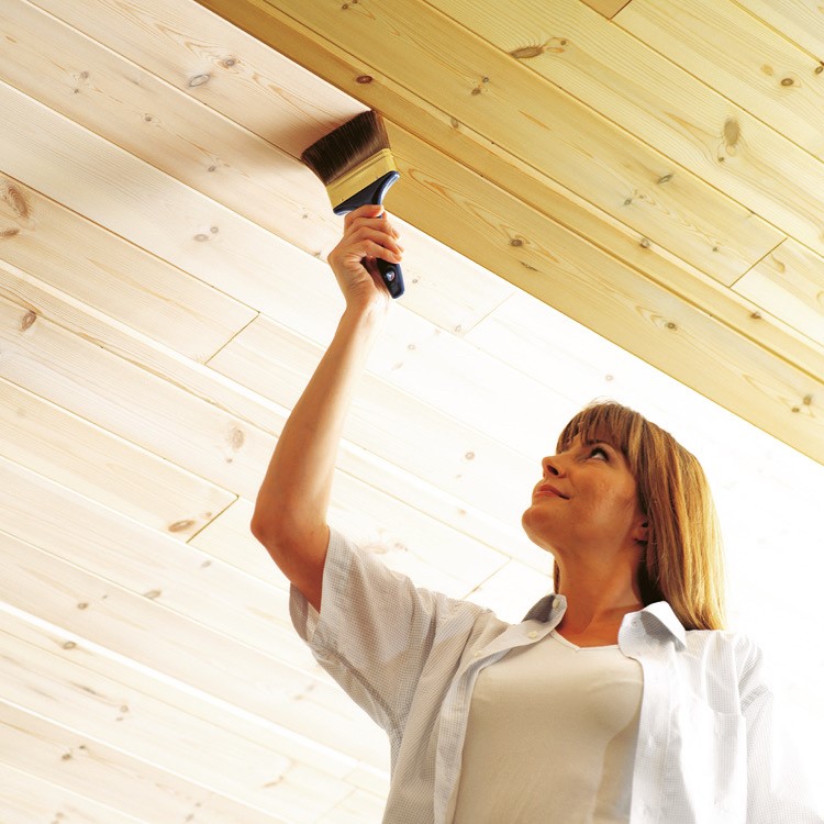 Dame maler med hvid panellud på loft